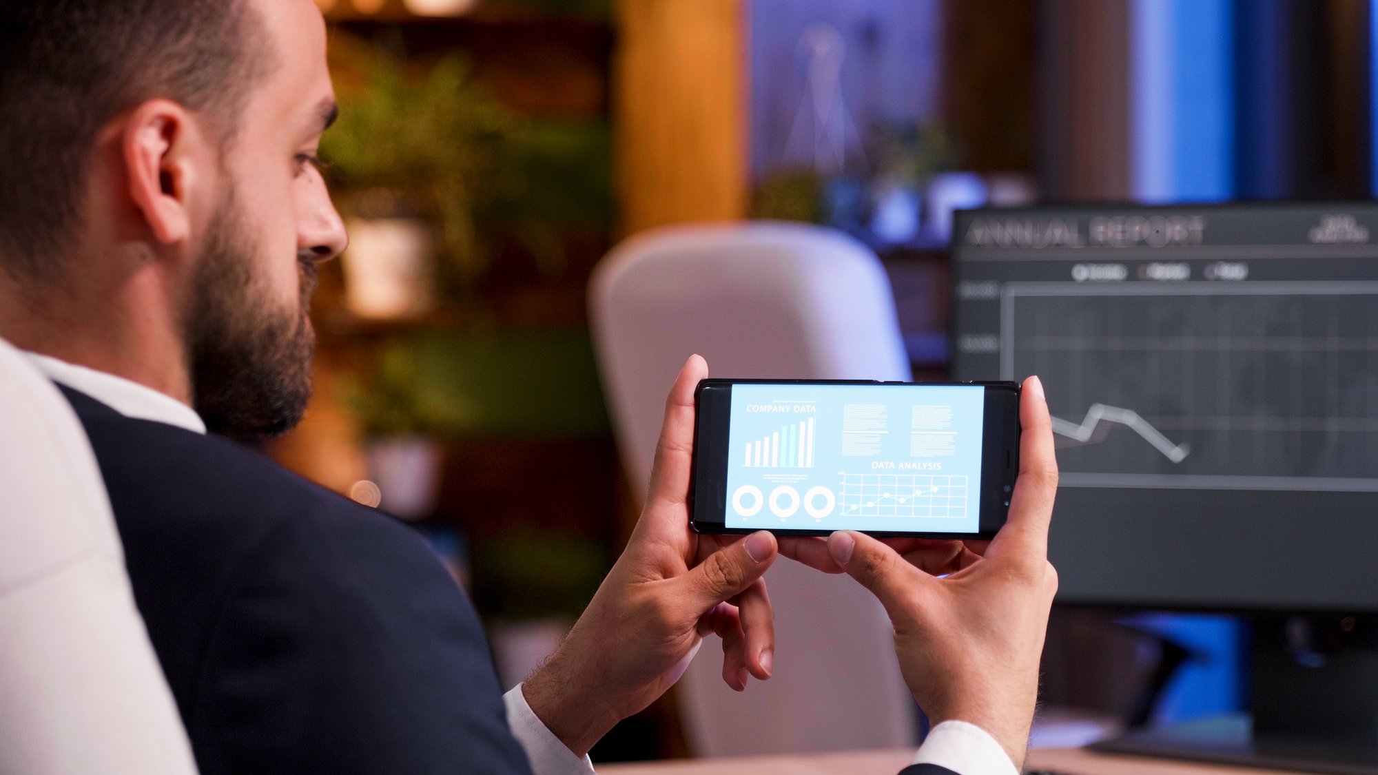 manager-who-keeps-track-sales-figures-phone-screen-moon-light